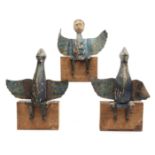 India, three painted wooden figures with metal wings on wooden stands.