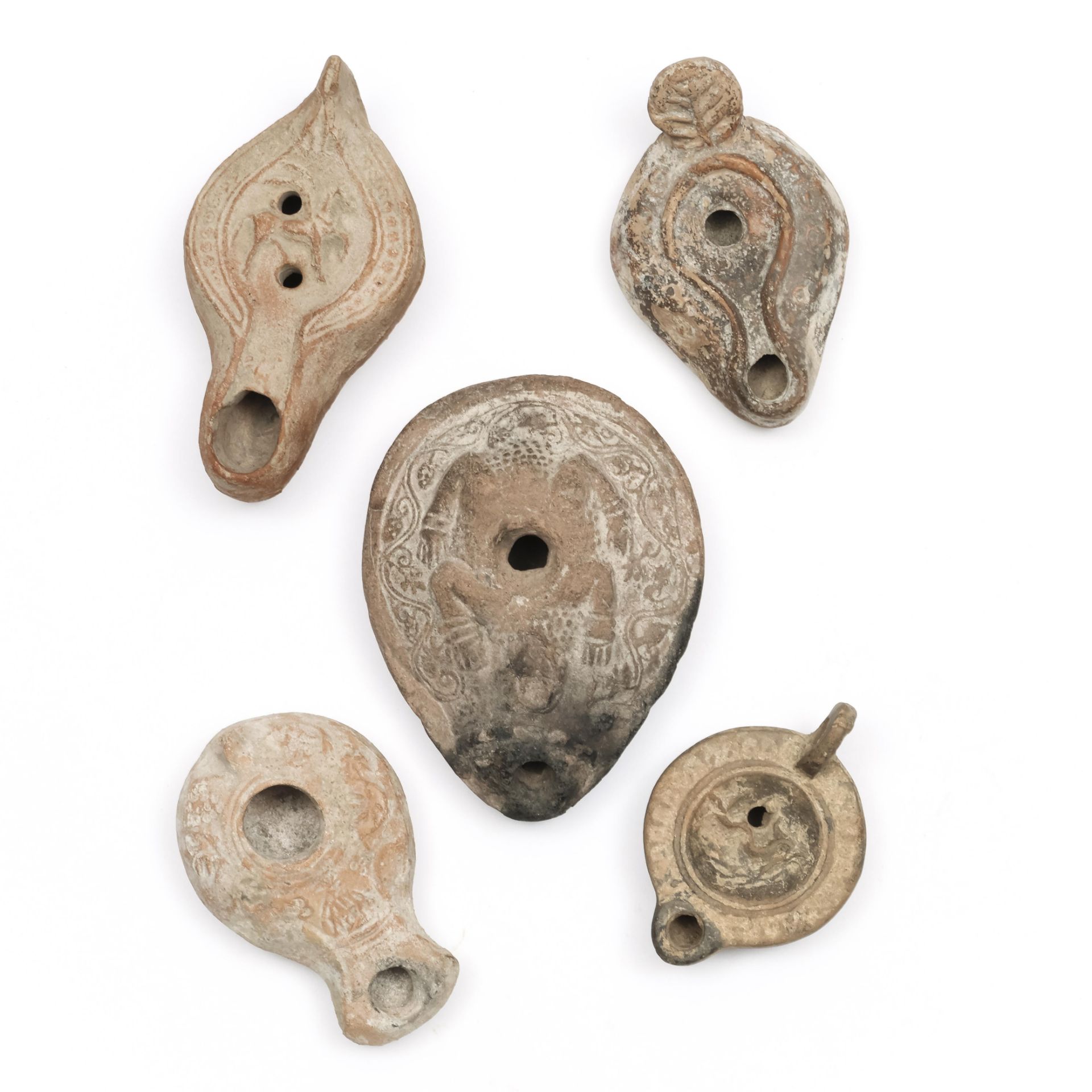 Five various terracotta oil lamps; Near Eastern and Roman.