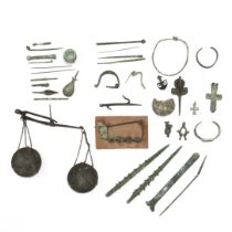 A collection of bronze antique artifacts, a.o. Roman bronze fibulae, pins, bracelet, ca. 2nd century