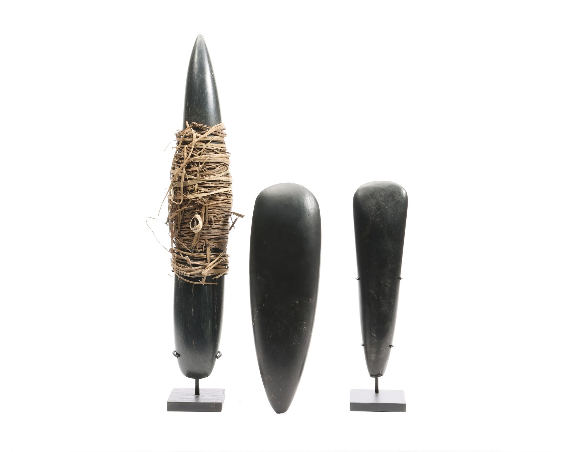 Papua, two stone axe blades and a currency stone blade