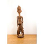 Mali, Dogon, a large decorative sculpture of a mother and child; herewith a Greenland mask