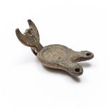 A Roman terracotta oil lamp with double sprout ca. 1st century AD.,