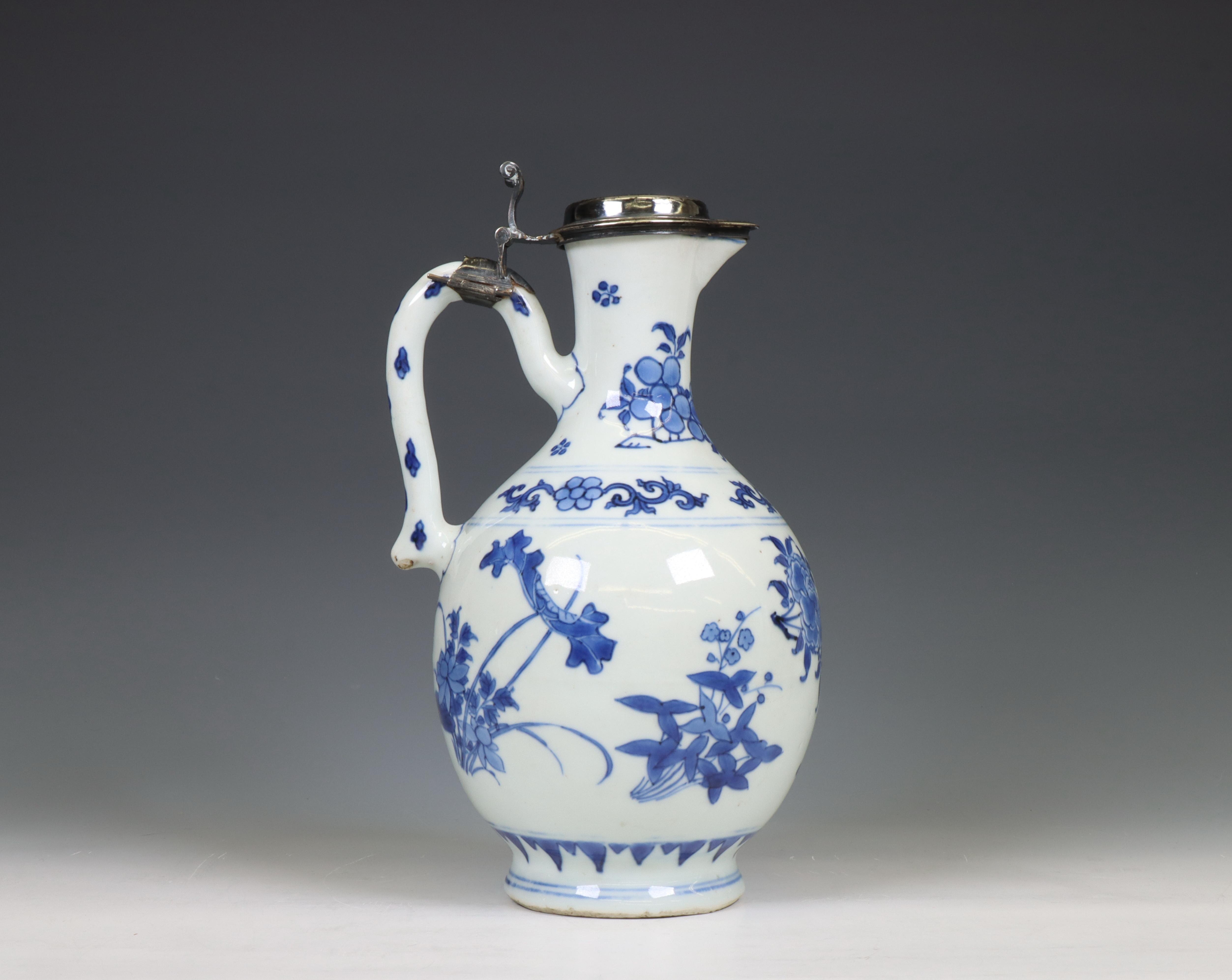 China, a Transitional silver-mounted blue and white porcelain ewer, mid 17th century, the silver lat - Image 2 of 6
