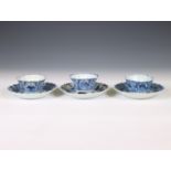 China, a set of three blue and white porcelain 'fisherman' cups and saucers, 18th century,