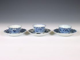 China, a set of three blue and white porcelain 'fisherman' cups and saucers, 18th century,