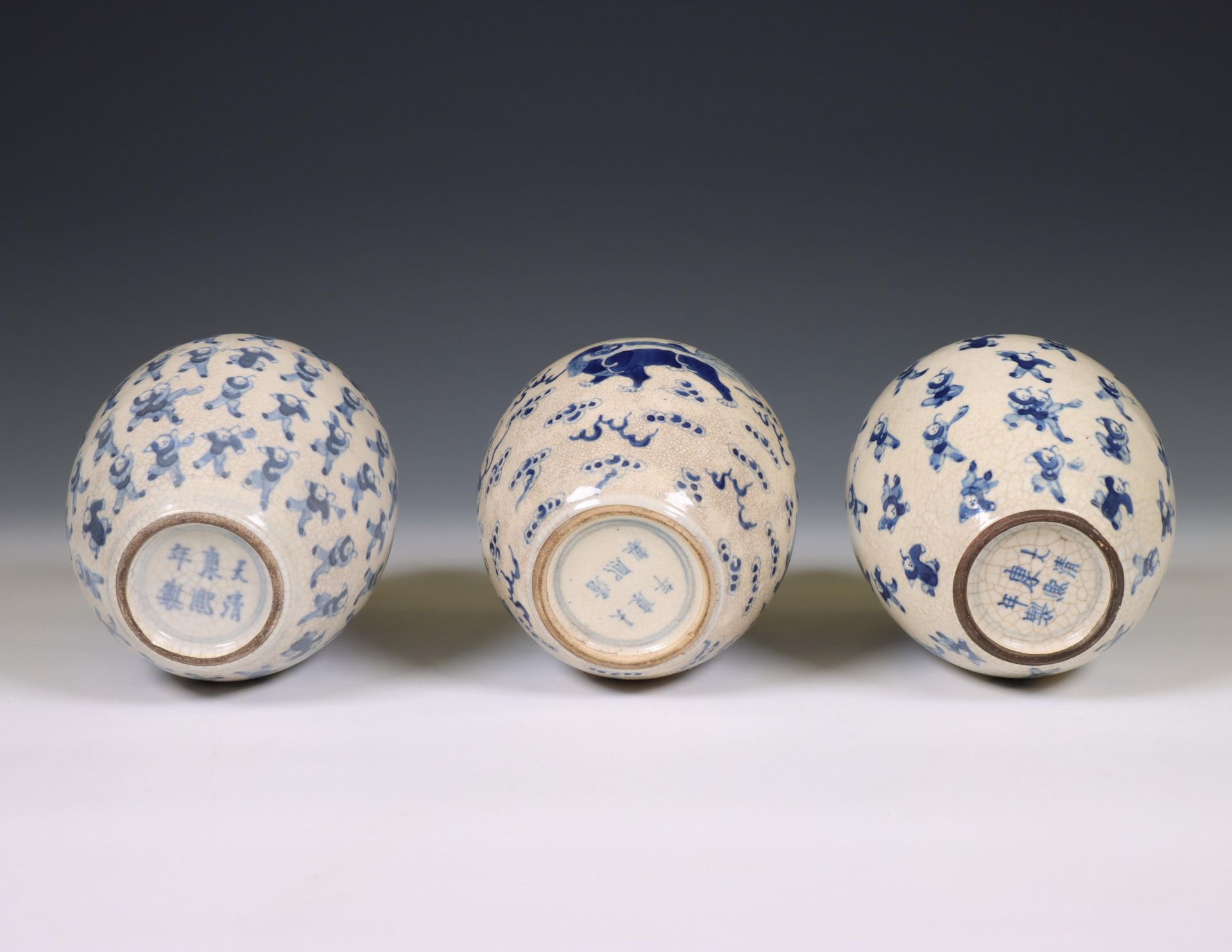 China, a pair of soft paste blue and white 'one hundred boys' jars and A 'buddhist lion' jar, 19th c - Image 3 of 4