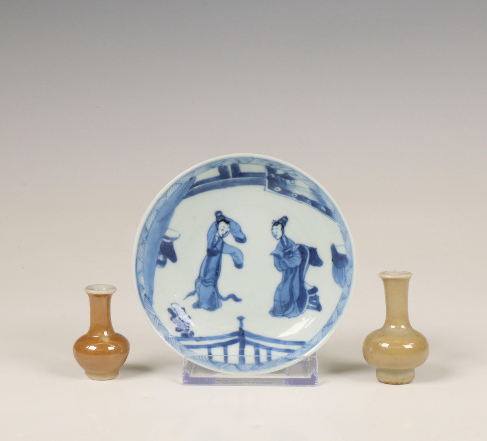 China, a blue and white porcelain saucer and two café-au-lait-glazed miniature vases, 18th century,