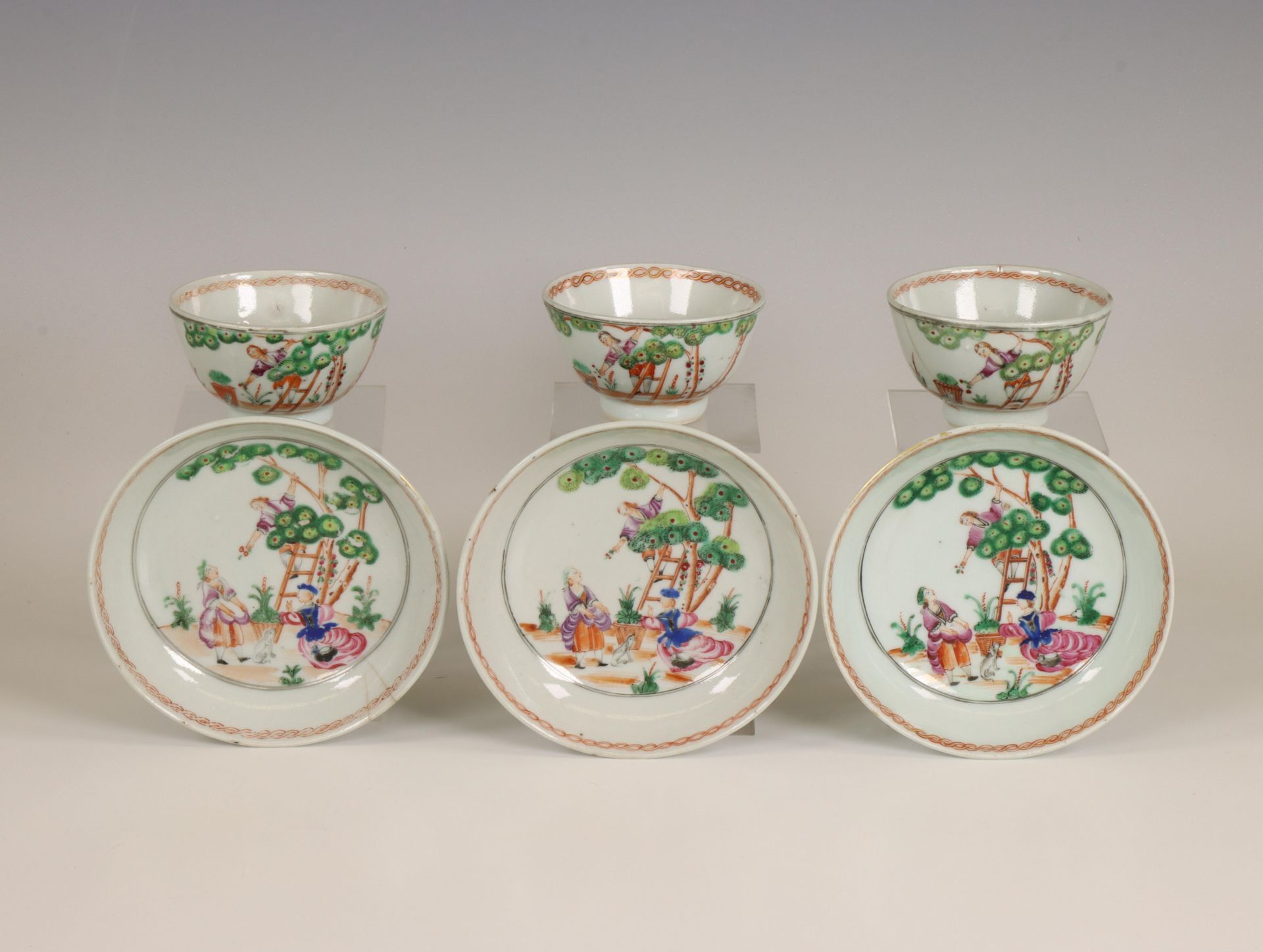 China, a set of three export porcelain 'Cherry Pickers' cups and saucers, 18th century,