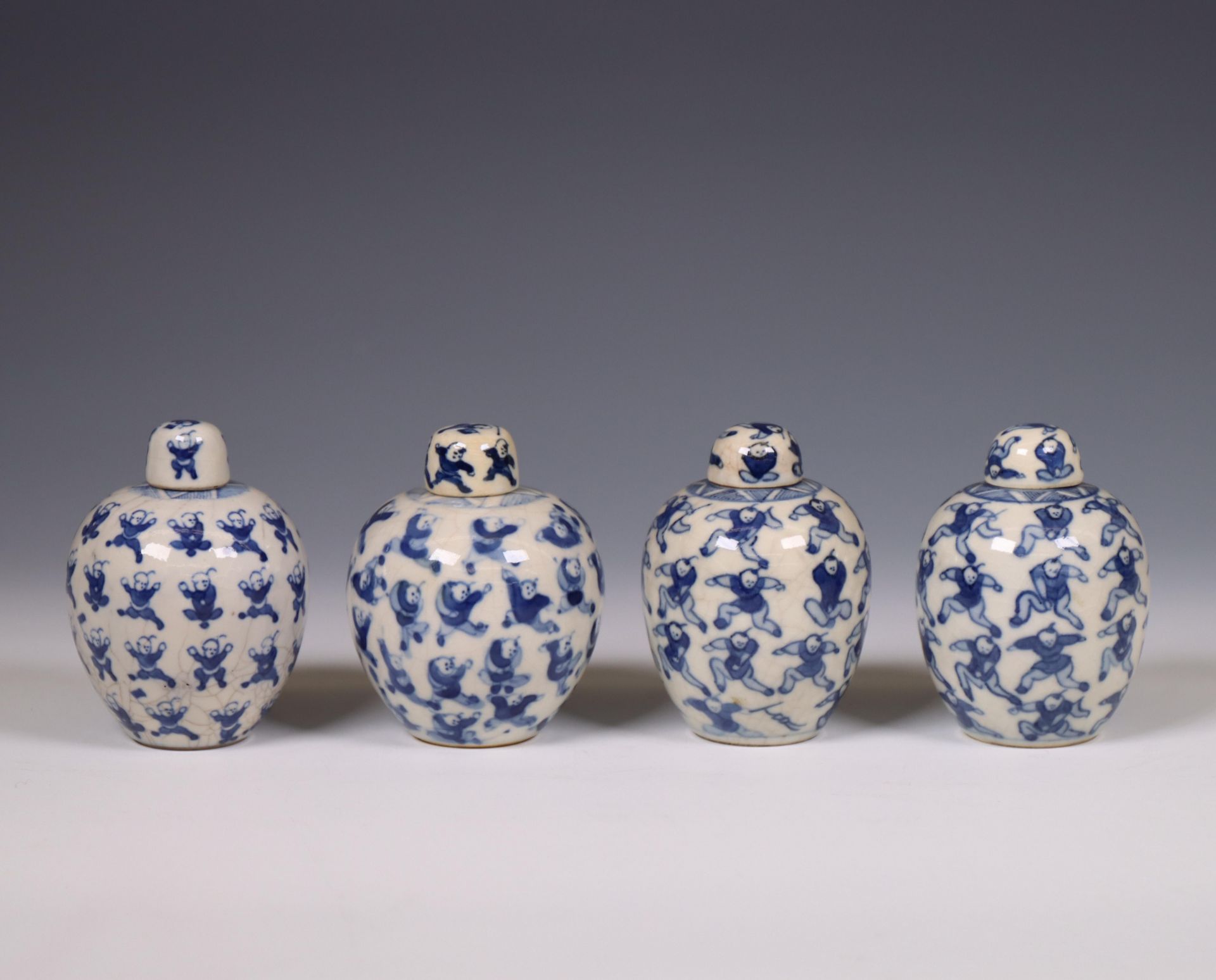 China, four soft paste blue and white 'one hundred boys' jarlets and covers, 19th century,