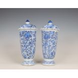 China, a pair of blue and white porcelain beaker vases and covers, Kangxi period (1662-1722),