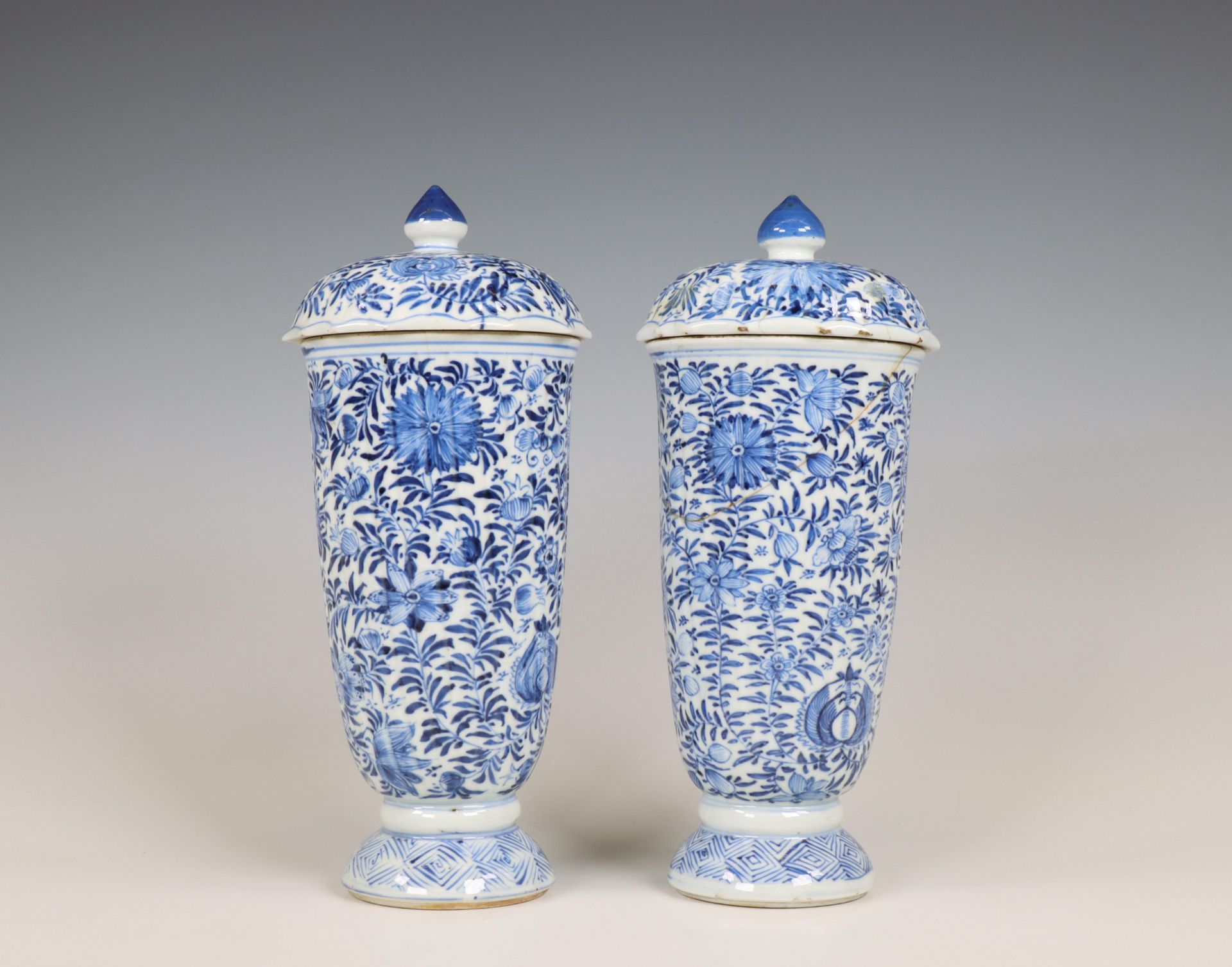 China, a pair of blue and white porcelain beaker vases and covers, Kangxi period (1662-1722),