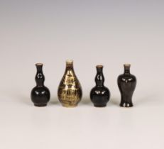 China, four black-glazed miniature vases,