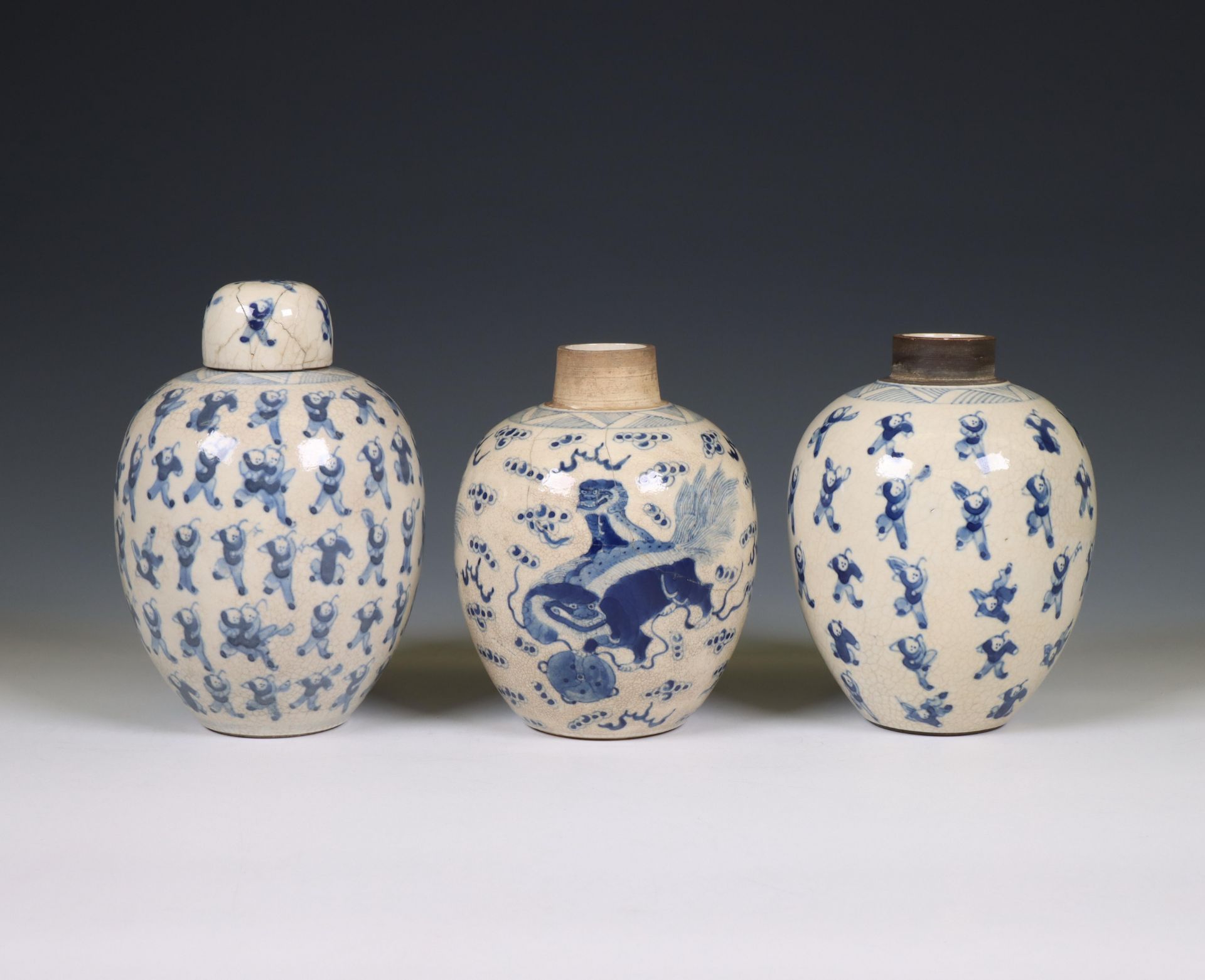 China, a pair of soft paste blue and white 'one hundred boys' jars and A 'buddhist lion' jar, 19th c