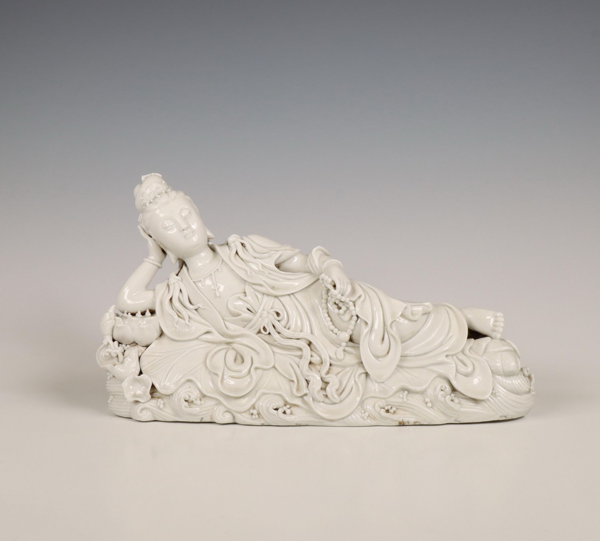 China, a Dehua porcelain reclining Guanyin, 20th century,