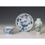 China, a blue and white tea bowl, a saucer and a famille verte miniature vase, 18th-19th century,