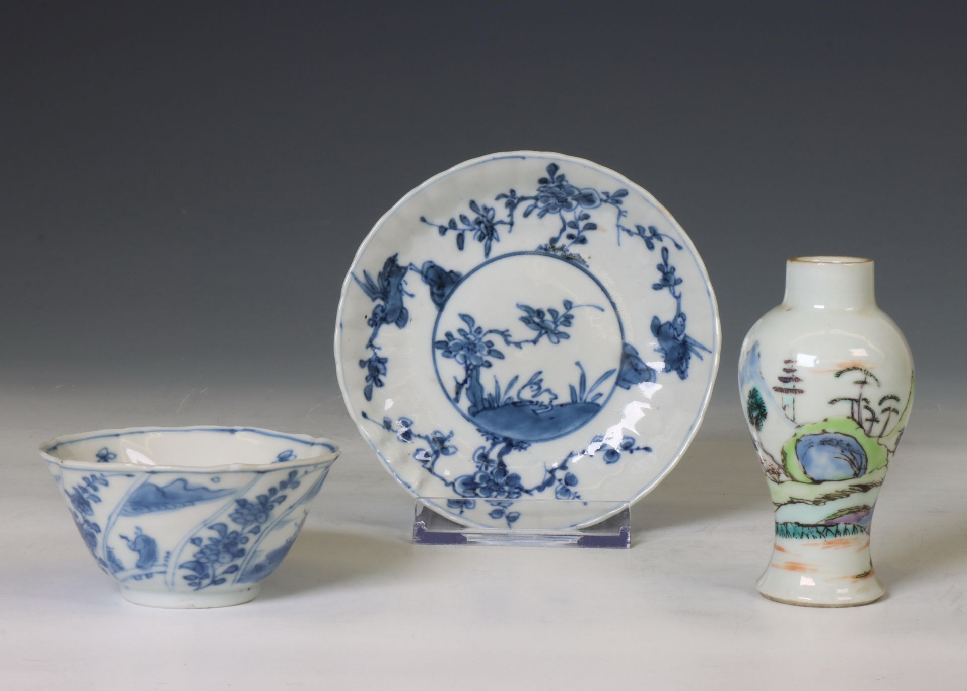 China, a blue and white tea bowl, a saucer and a famille verte miniature vase, 18th-19th century,