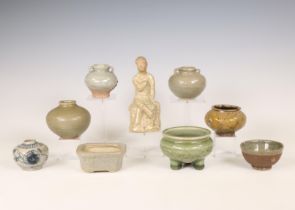 China and Southeast Asia, a collection of celadon and cream-glazed jars and a figure, Ming dynasty (