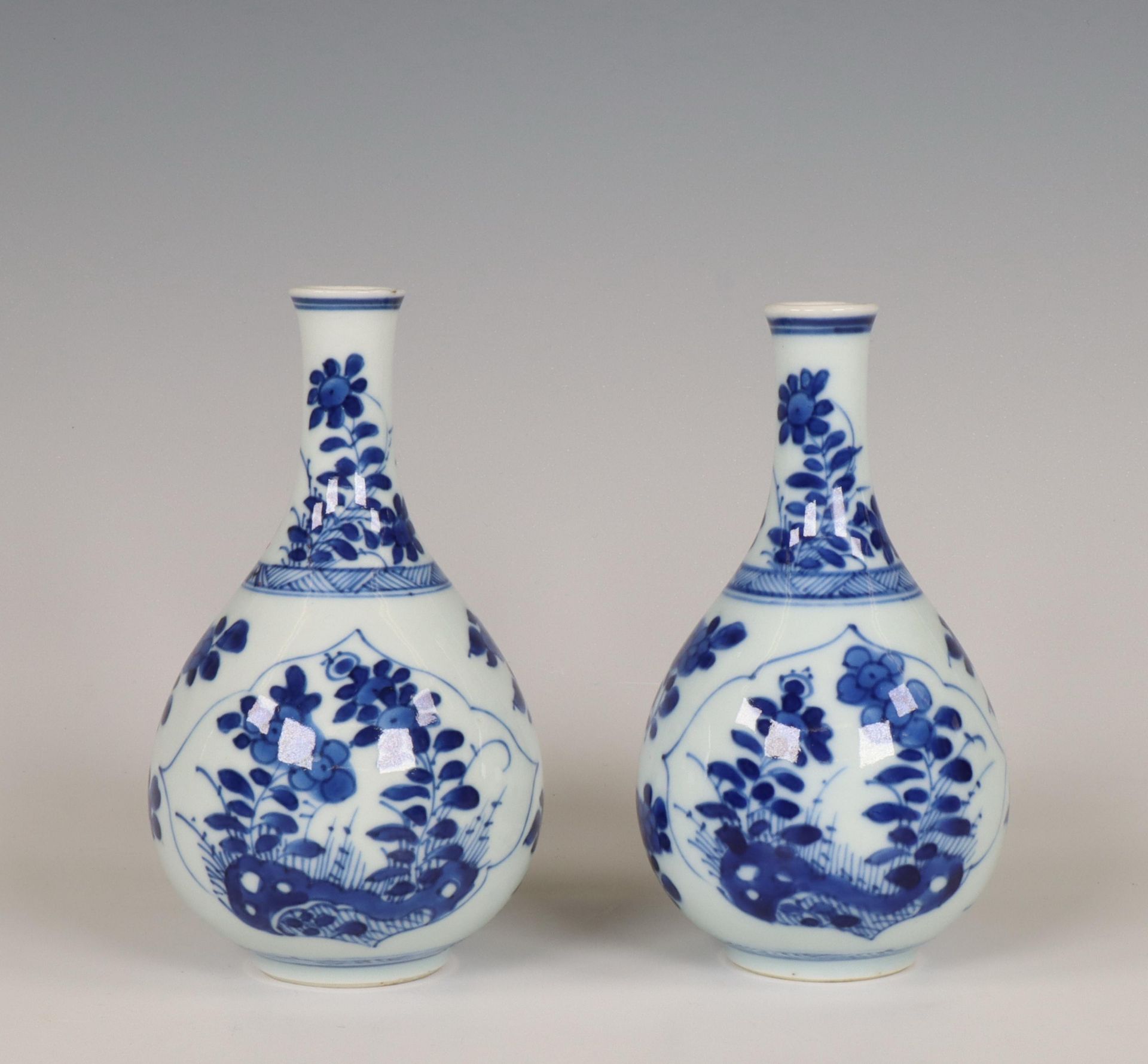 China, a pair of small blue and white porcelain bottle vases, Kangxi period (1662-1722),