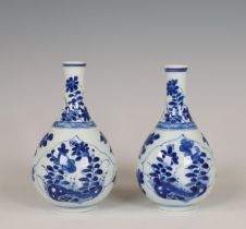 China, a pair of small blue and white porcelain bottle vases, Kangxi period (1662-1722),
