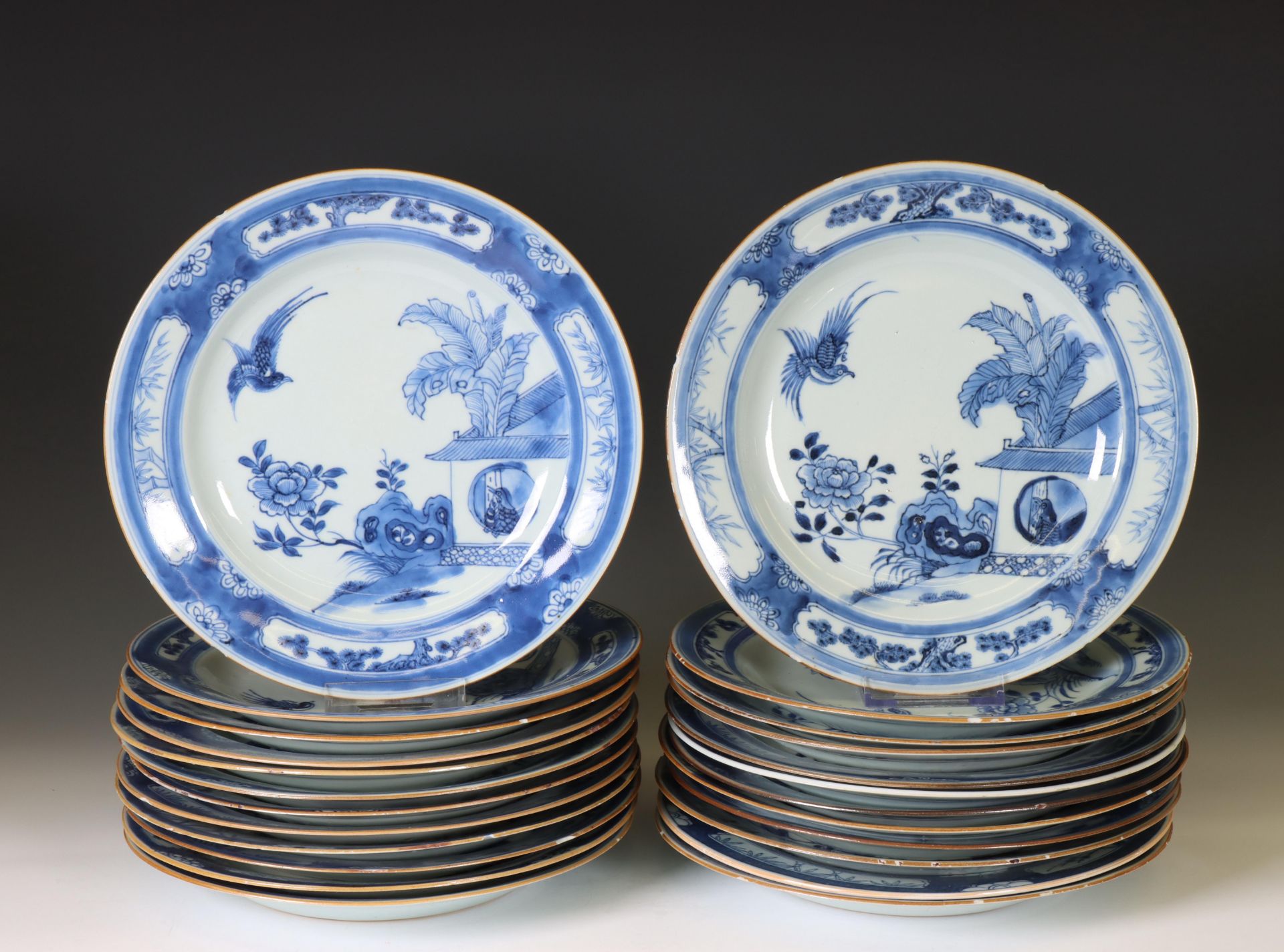 China, a set of twenty-four blue and white porcelain 'Cuckoo in the House' plates, 18th century,