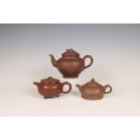 China, three Yixing earthenware teapots and covers, 19th-20th century,