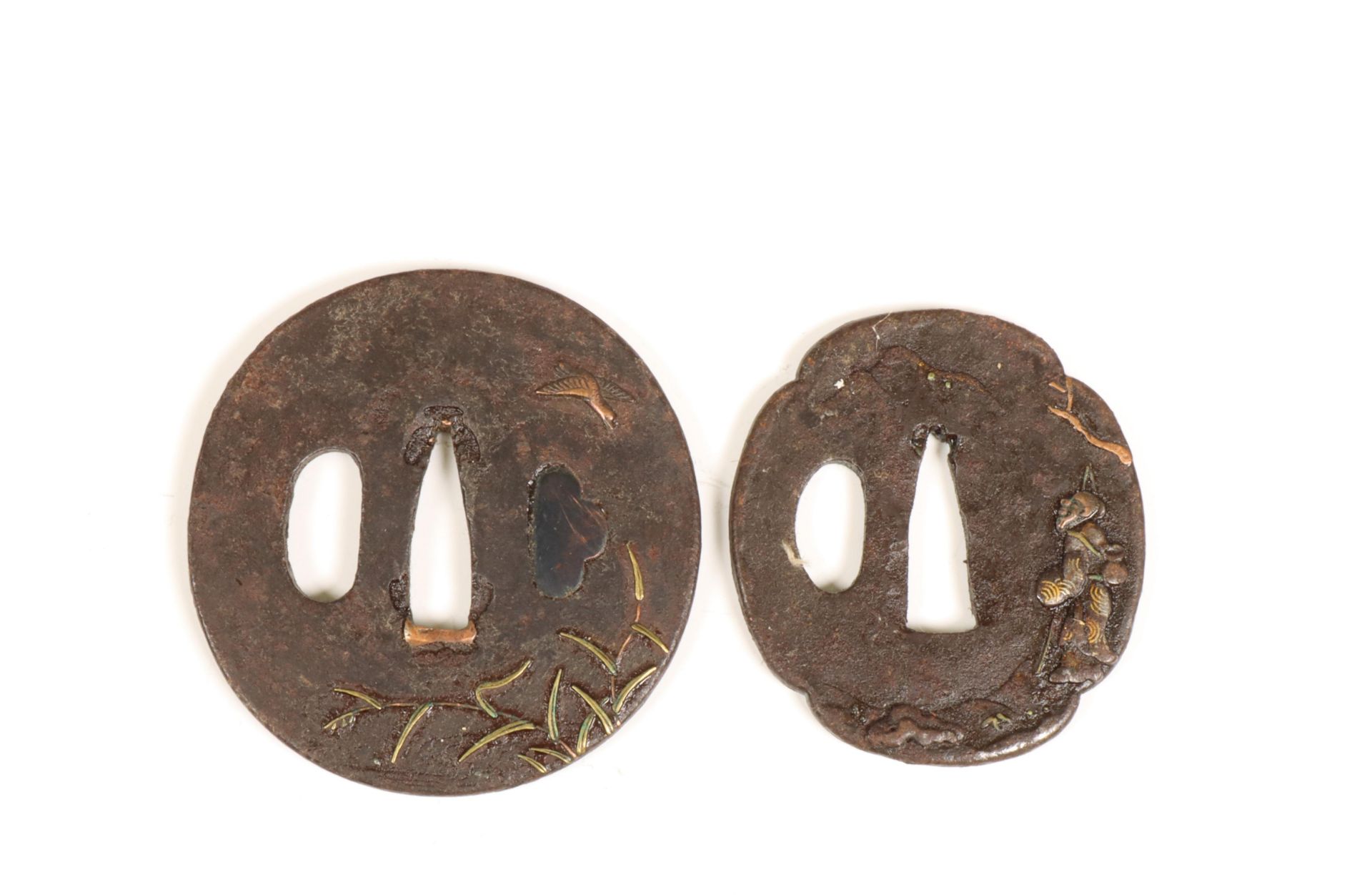 Japan, two iron tsuba's with gold- and silver inlay, Edo period (1615-1868);