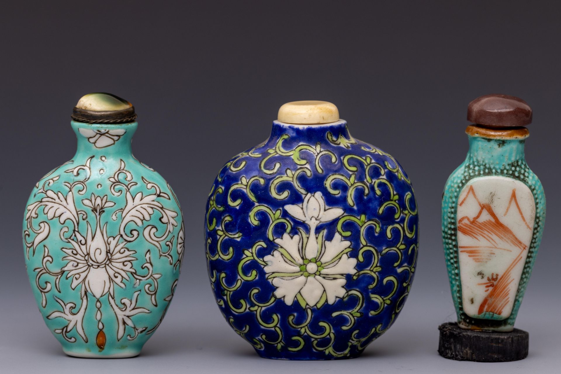 China, three polychrome porcelain snuff bottles and stoppers, late Qing dynasty (1644-1912),