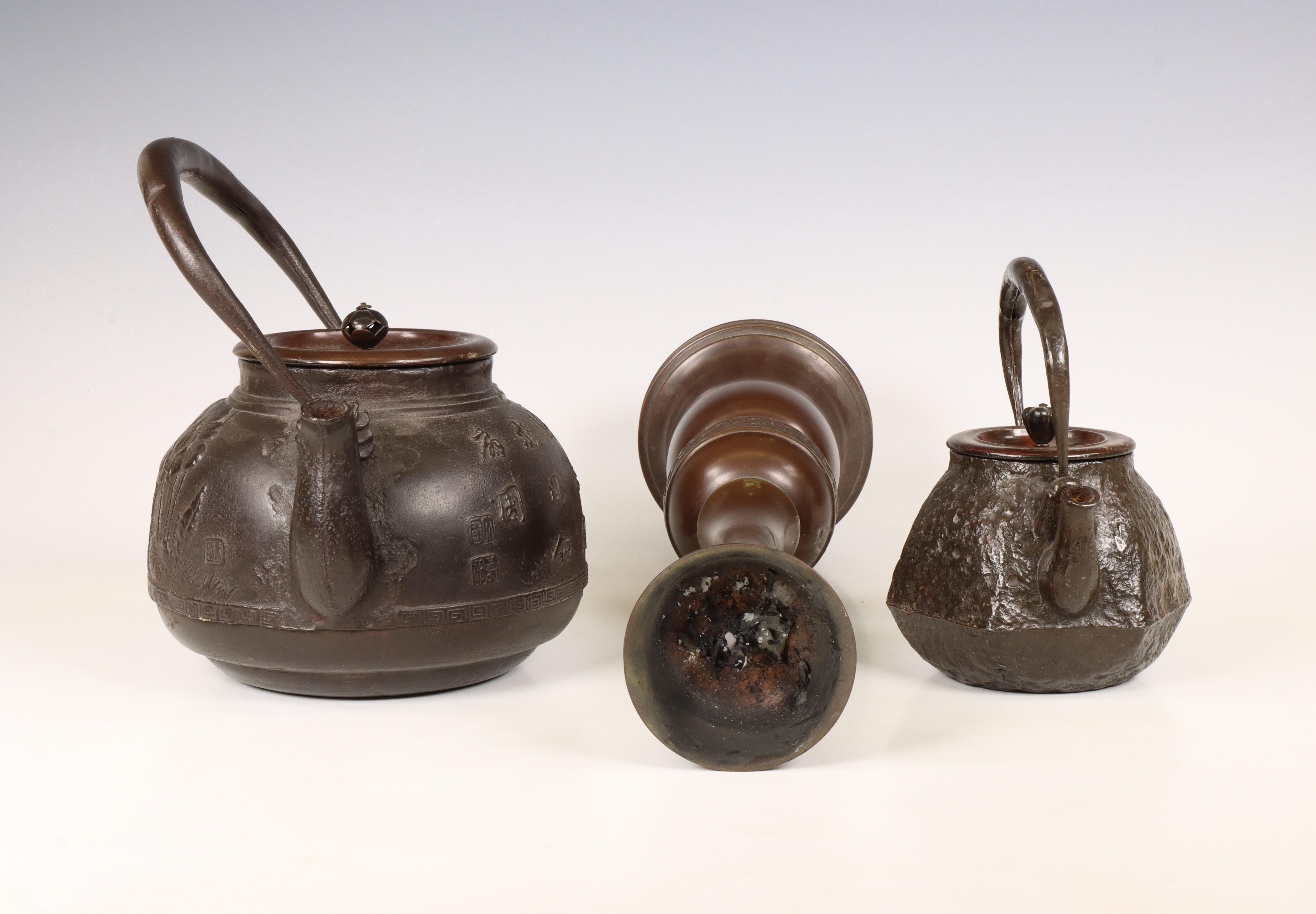 Japan, two iron kettles and a bronze candlestick, 20th century, - Image 3 of 4