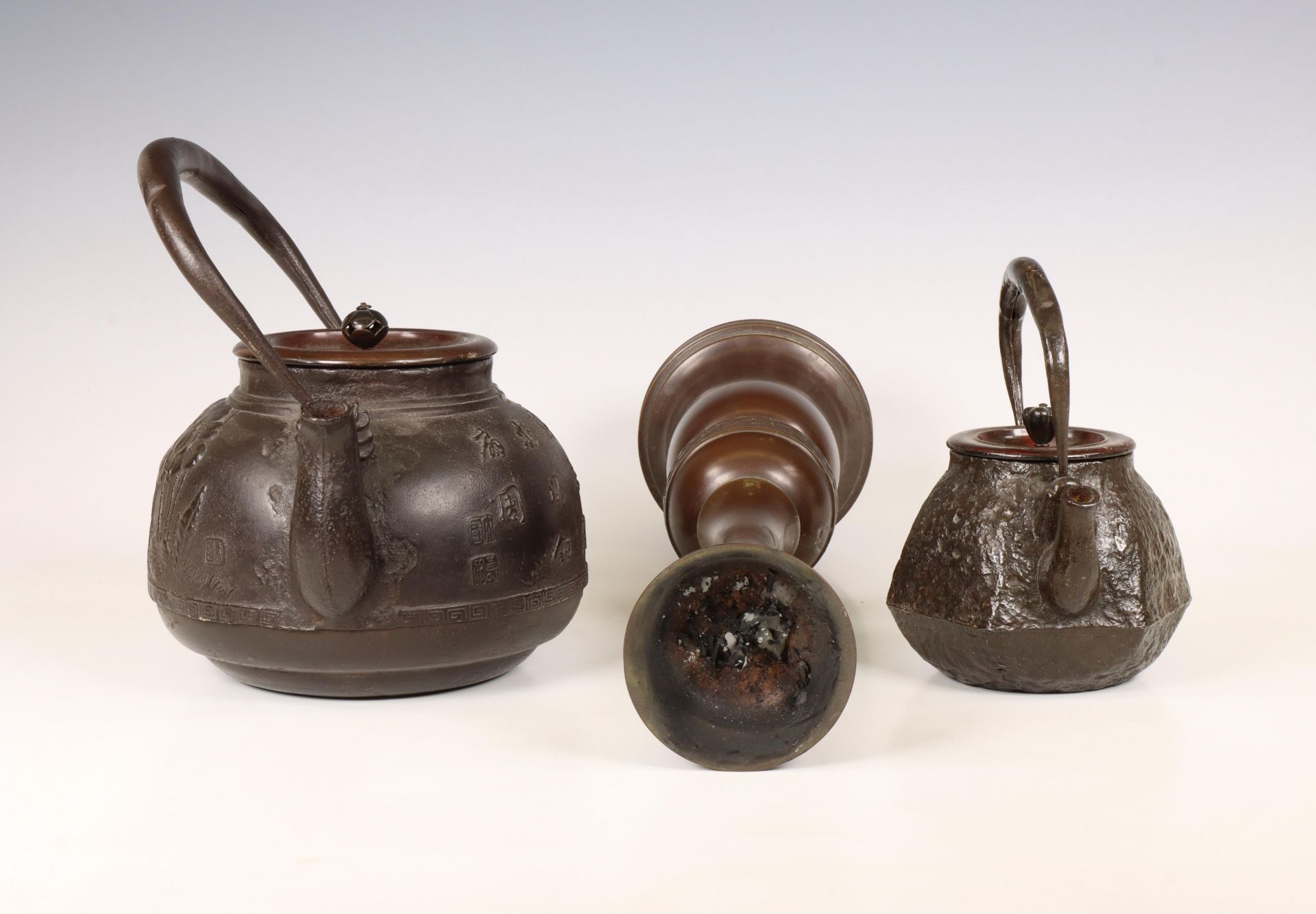 Japan, two iron kettles and a bronze candlestick, 20th century, - Image 3 of 4