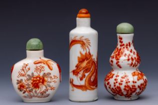 China, three iron-red decorated porcelain snuff bottles and stoppers, late 19th/ 20th century,