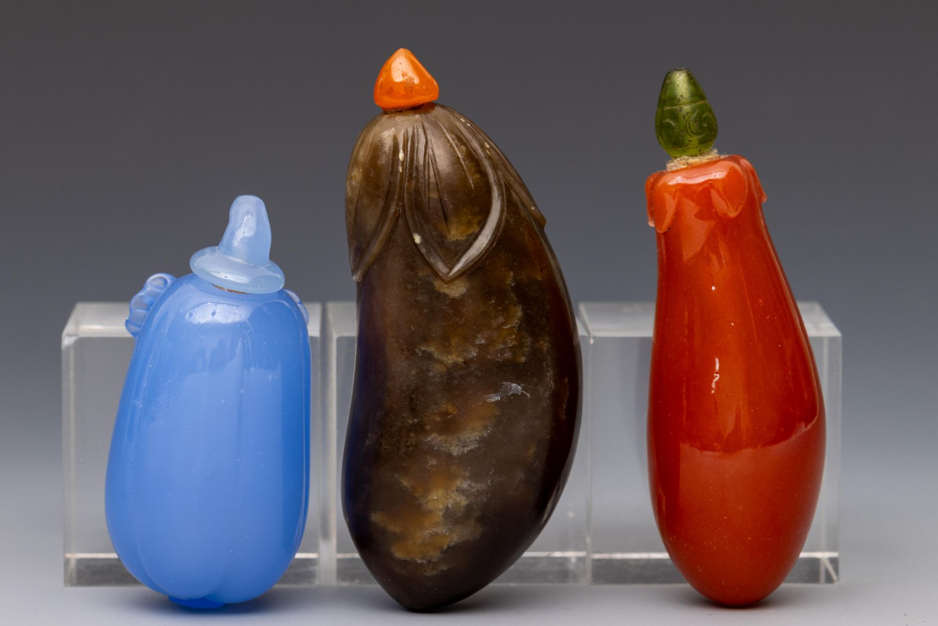 China, two glass and one agate 'gourd' snuff bottles and stoppers, late Qing dynasty (1644-1912),