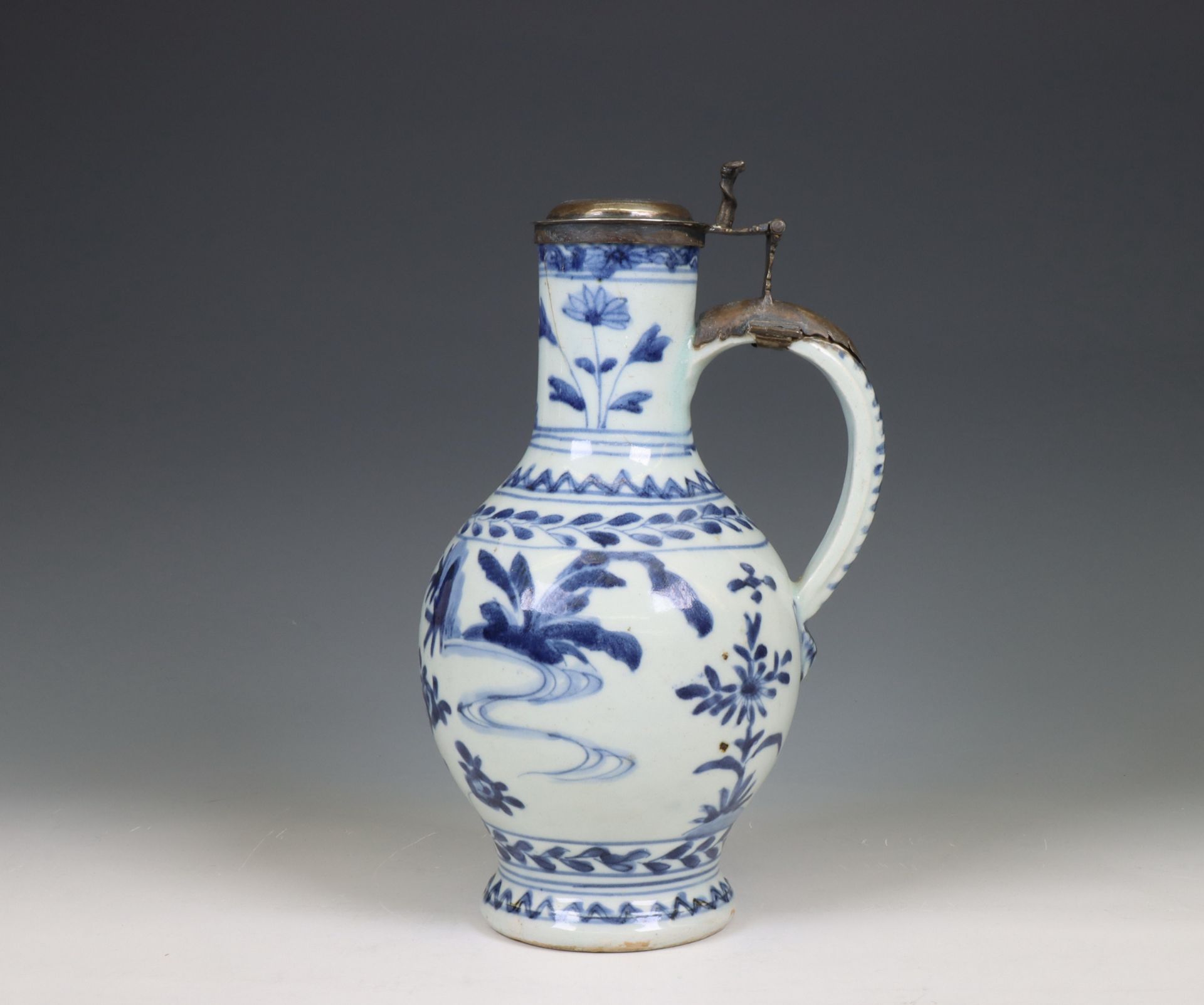 Japan, Arita blue and white silver-mounted porcelain jug, 17th century, the silver later,