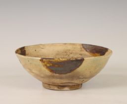China, a cream-glazed pottery bowl, probably Tang dynasty (618-907),