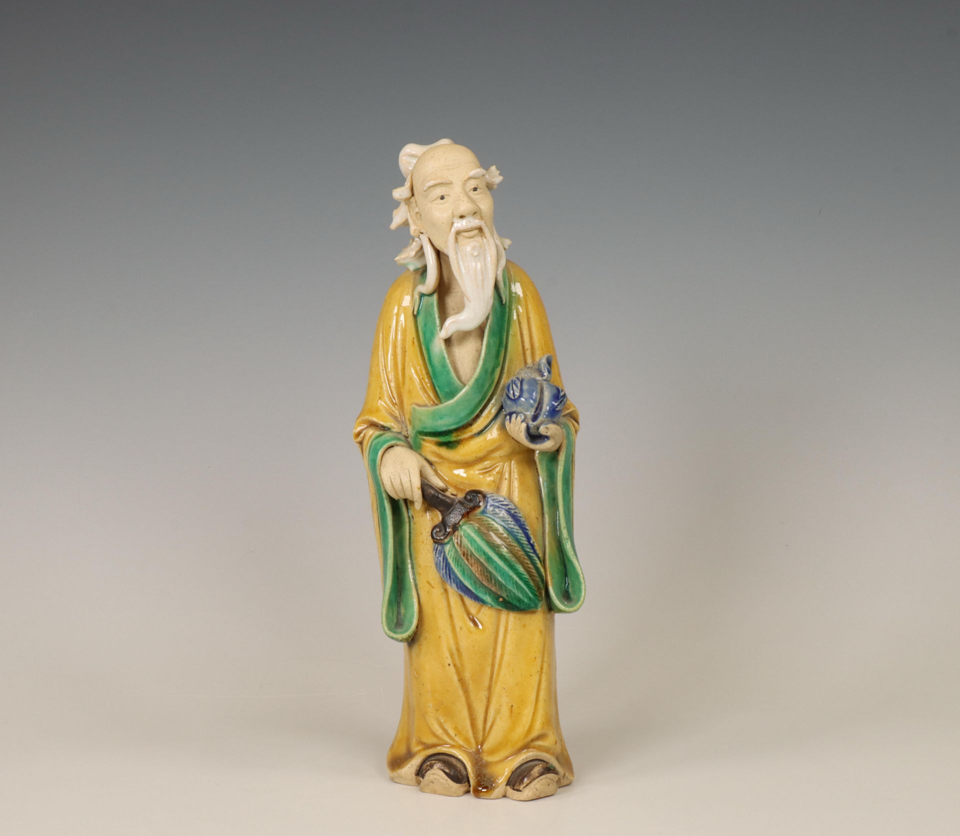 China, a biscuit sancai-glazed figure of an Immortal, modern,