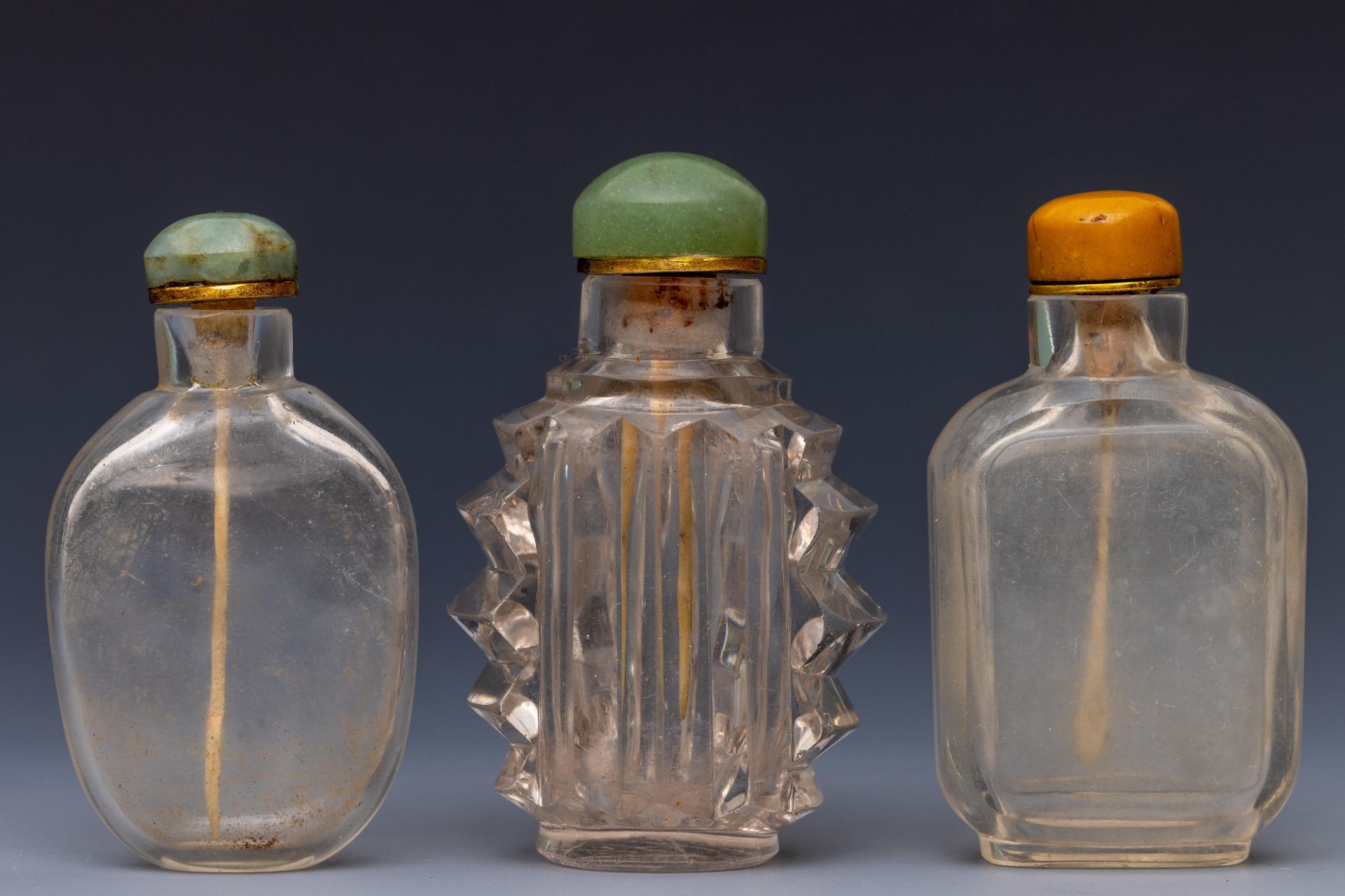 China, three translucent glass snuff bottles and stoppers, late Qing dynasty (1644-1912),