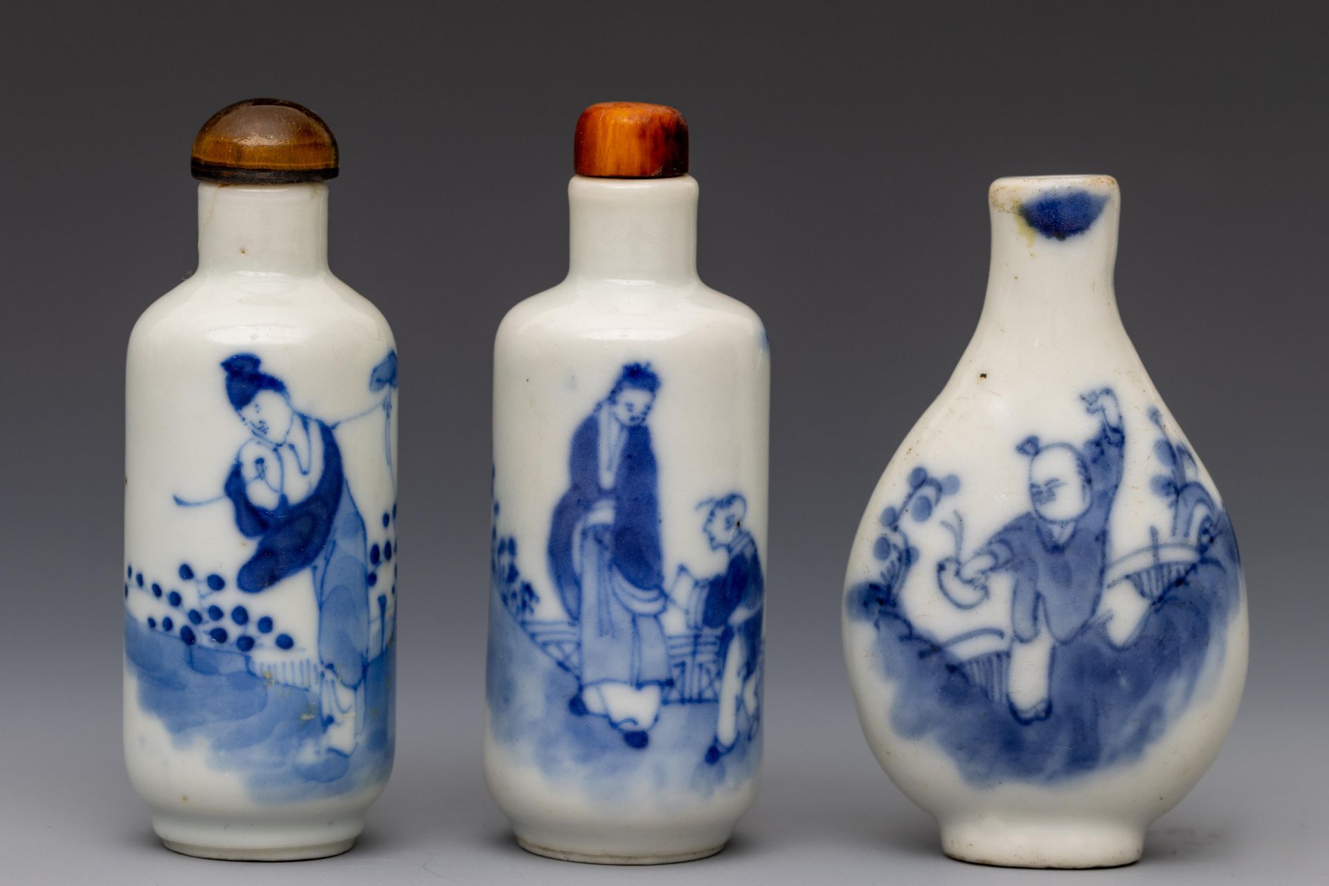 China, three blue and white porcelain figural snuff bottles and two stoppers, 19th-20th century,