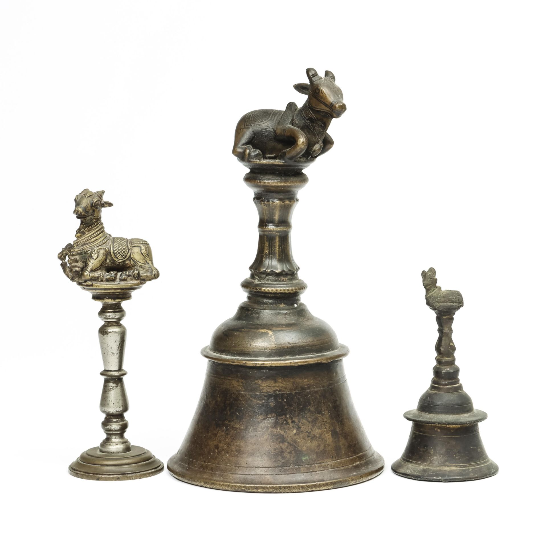 South-India, two priest hand bells surmounted by Nandi and a bull figure on a pedistal, 19th century