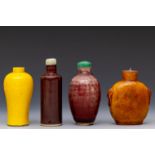 China, four red and yellow-glazed porcelain snuff bottles and two stoppers, 18th-19th century,