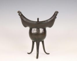 China, a bronze tripod ritual wine vessel, yue, Yuan or early Ming dynasty, 14th/ 15th century,