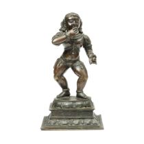 South India, a bronze figure of dancing Krishna, Navanita-nritta-krsna, 19th-20th century;