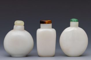 China, three opaque white glass snuff bottles and stoppers, 19th century,