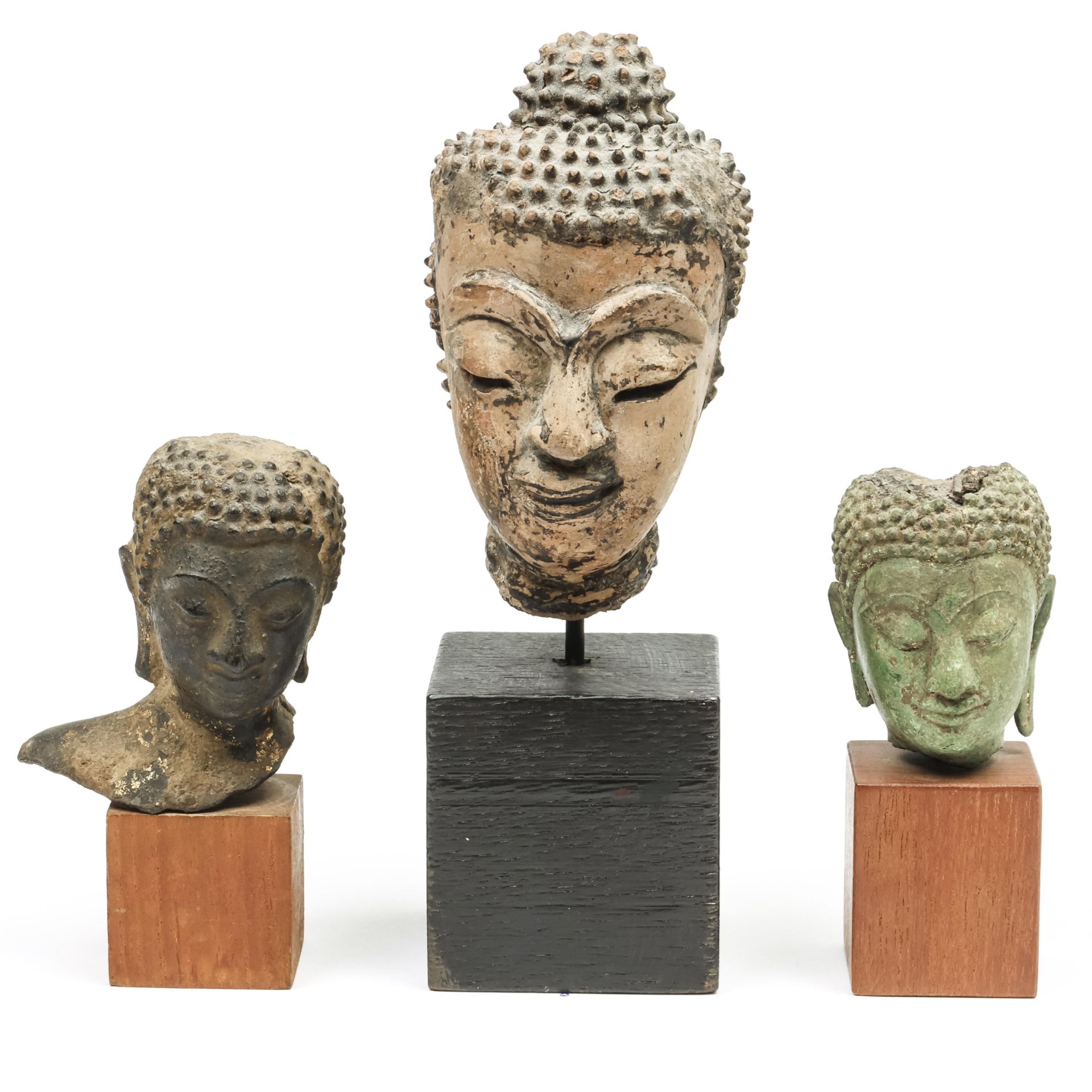 Thailand, a terracotta Buddha head and two bronze Buddha heads, 16th-18th century;