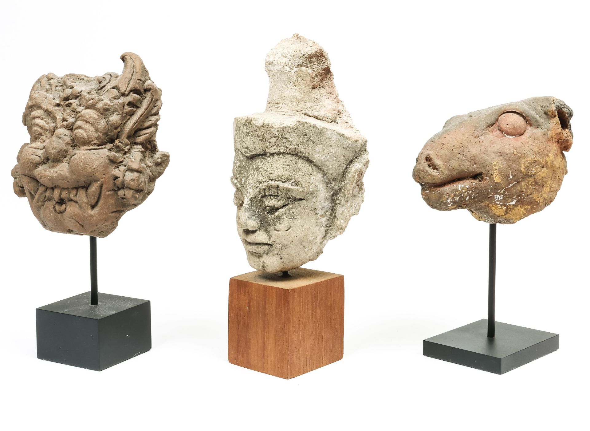 Thailand, a stucco head and Indonesia,a terracotta Ram's head and a demon head, ca. 19th century.