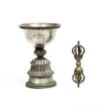 Tibet, a silver alloy butter lamp and a bronze dorje, 19th century;