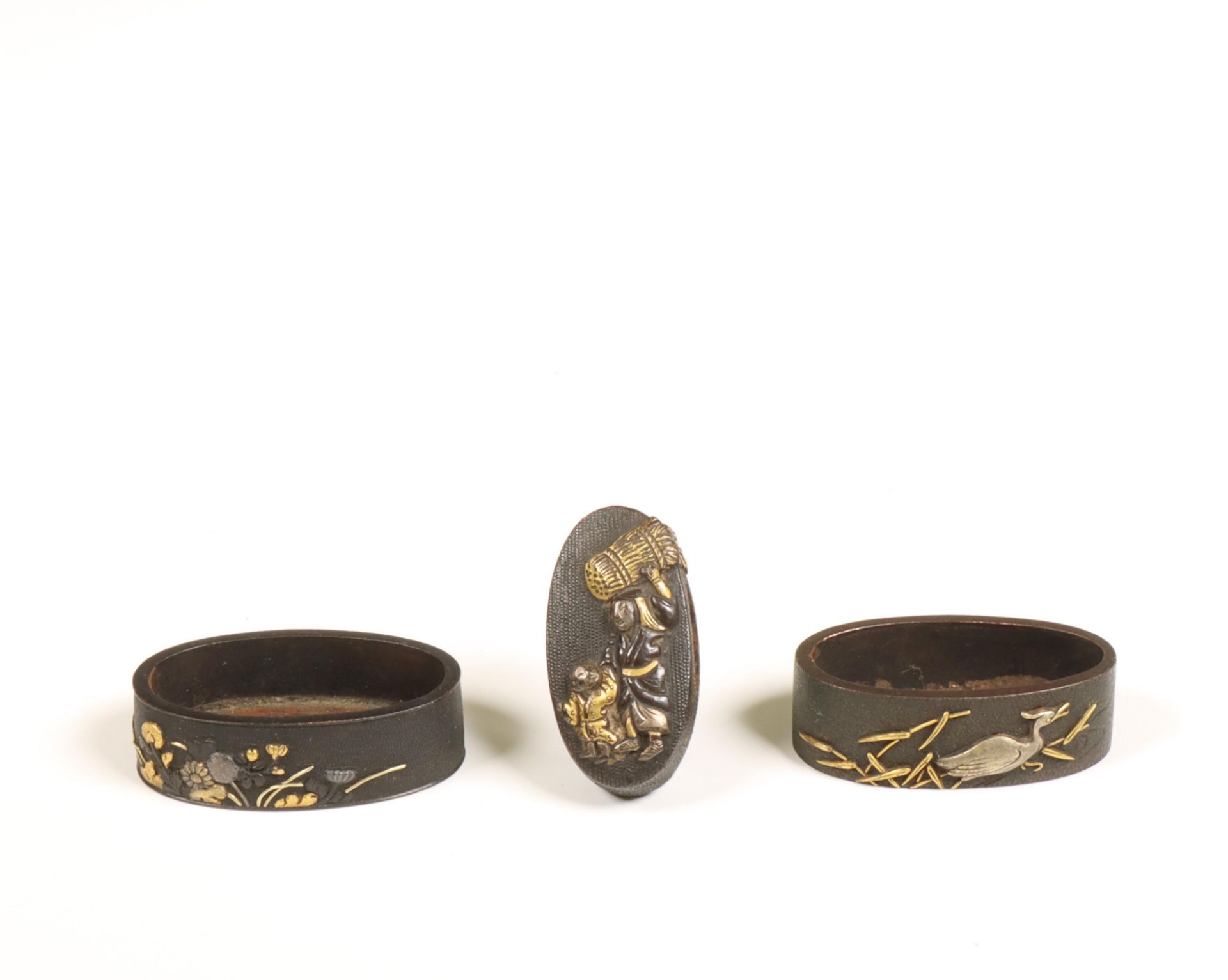 Japan, two iron fuchi and one kashira with gold- and silver inlay, Edo period, (1615-1868);