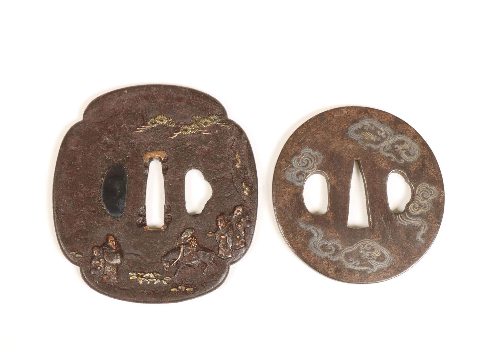 Japan, two iron tsuba's with gold- and silver inlay, Edo period (1615-1868);