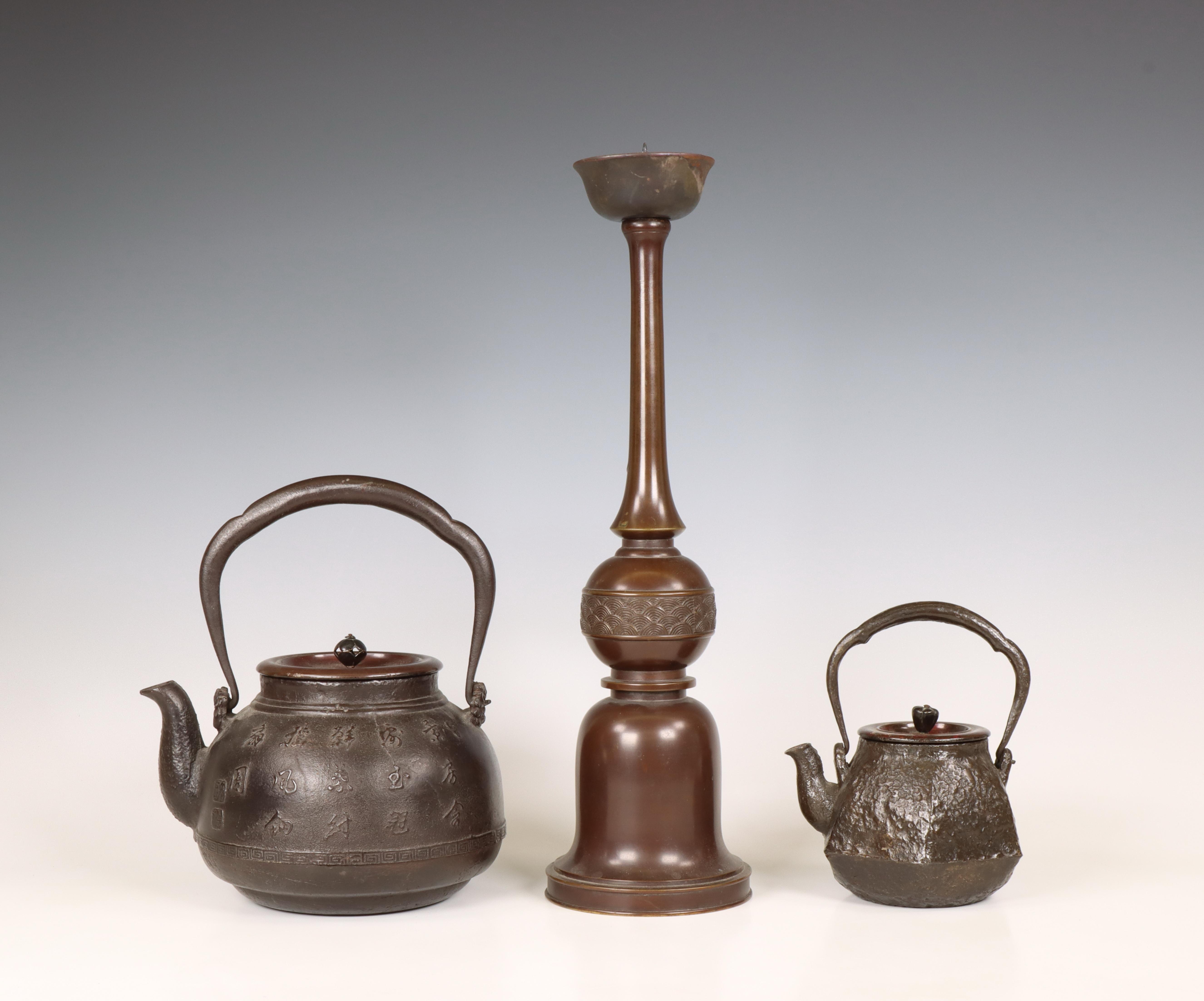 Japan, two iron kettles and a bronze candlestick, 20th century,