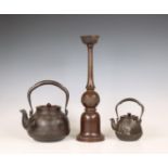 Japan, two iron kettles and a bronze candlestick, 20th century,