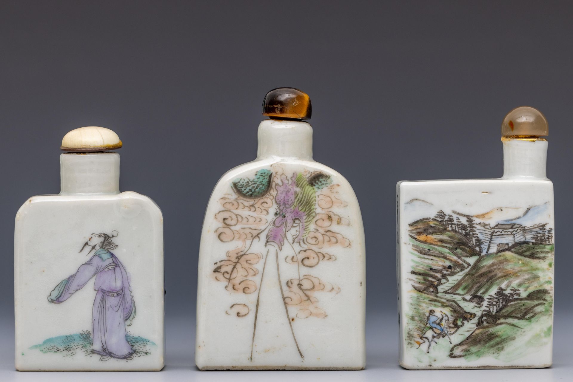 China, three polychrome decorated porcelain figural snuff bottles and stoppers, late Qing dynasty (1