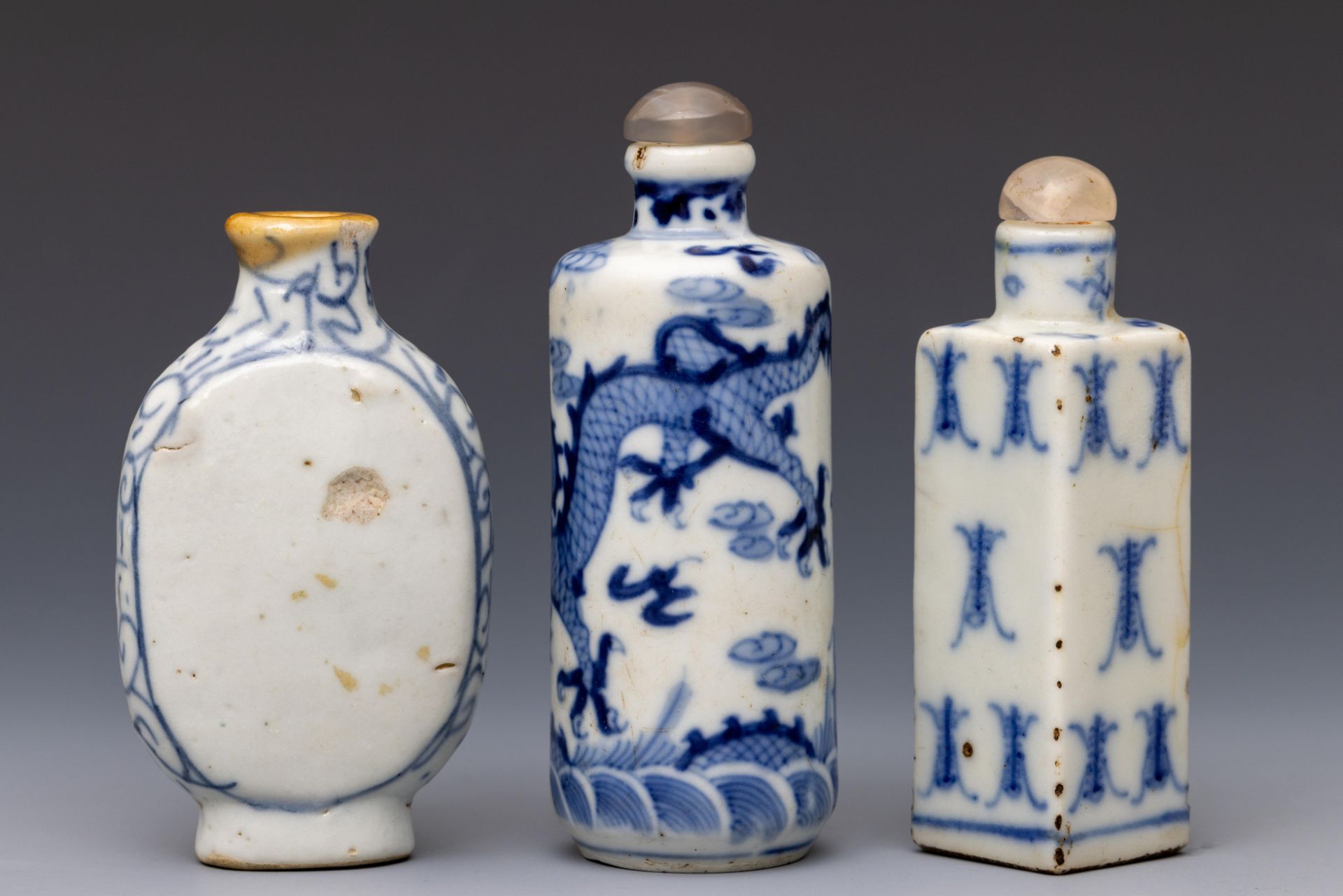 China, three blue and white porcelain snuff bottles and two stoppers, 20th century,